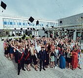 Graduates throwing the alumni hats