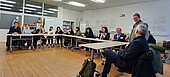 The delegation from Uzbekistan and representatives of the HWG LU discuss in a conference room.