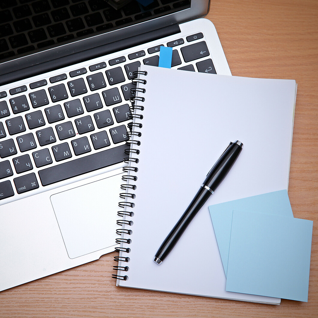 Laptop with writing utensils