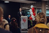 Minister Hoch at the lectern