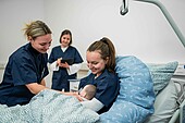 250724_Midwifery science Three midwifery students recreate a scene on the maternity ward with a baby doll